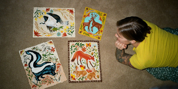 Jennifer Tanay on the floor with some of her prints