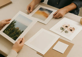 Artist reviewing print samples and file notes for when to use mounted prints