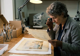 A scientist examines an old print in a lab