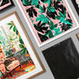 Overhead arrangement of black, white, and walnut-stain framed art prints thumbnail