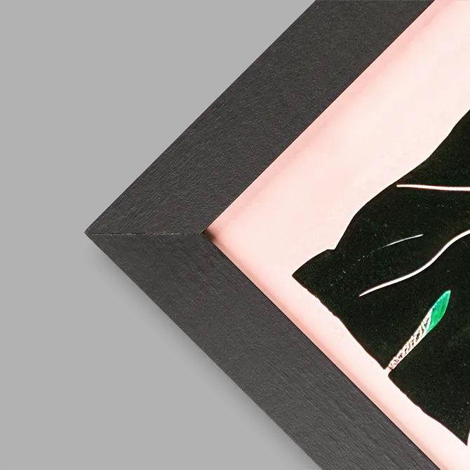 Close-up of a black framed print corner with pink artwork