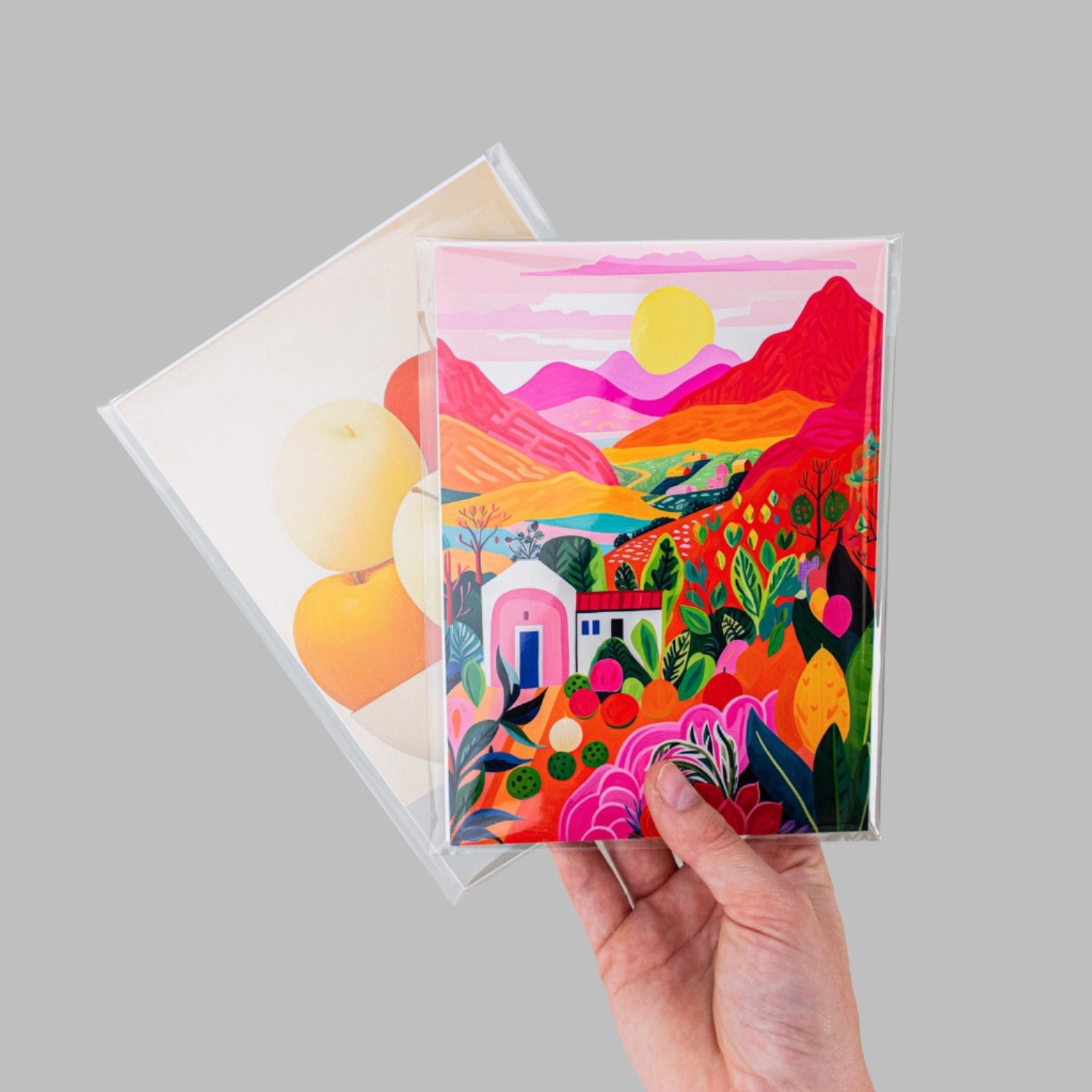 Two retail ready art prints with backing boards inside clear protective bags